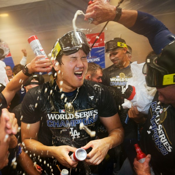 FILE- Los Angeles Dodgers' Shohei Ohtani celebrates in the locker room after their win against the New York Yankees in Game 5 to win the baseball World Series, Thursday, Oct. 31, 2024, in New York. (AP Photo/Ashley Landis, File)