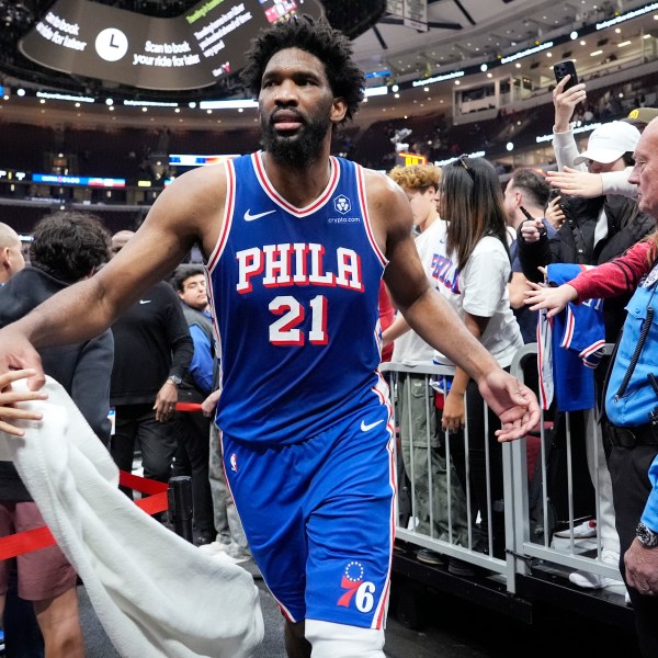 Philadelphia 76ers center Joel Embiid (21) celebrates with fans as he walks off the court after his team defeated the Chicago Bulls in an NBA basketball game in Chicago, Sunday, Dec. 8, 2024. (AP Photo/Nam Y. Huh)