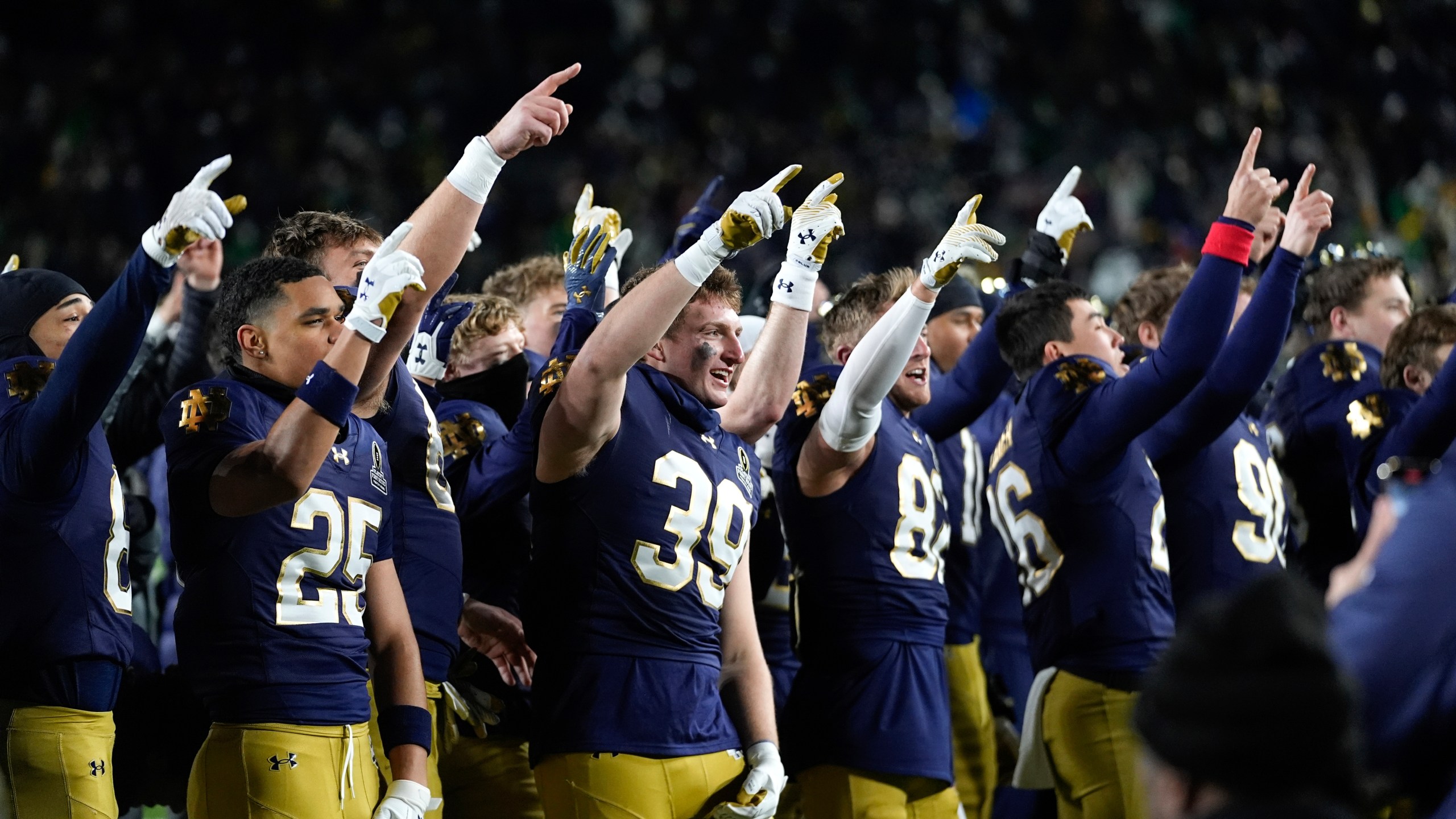 Notre Dame players celebrate after beating Indiana 27-17 in the first round of the NCAA College Football Playoff, Friday, Dec. 20, 2024, in South Bend, Ind. (AP Photo/Darron Cummings)