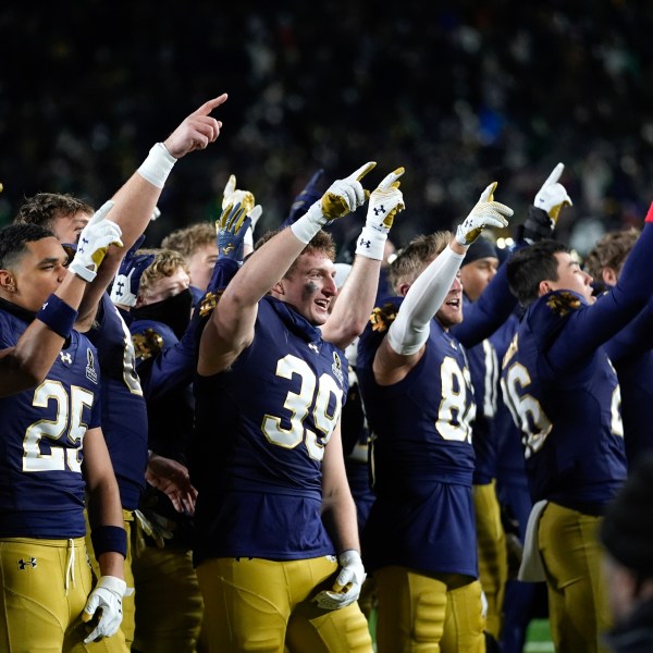 Notre Dame players celebrate after beating Indiana 27-17 in the first round of the NCAA College Football Playoff, Friday, Dec. 20, 2024, in South Bend, Ind. (AP Photo/Darron Cummings)