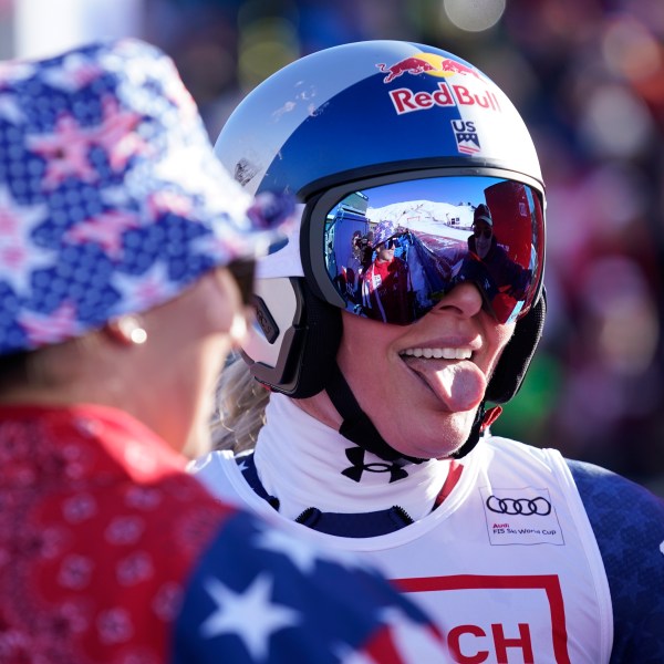 United States' Lindsey Vonn celebrates at the finish area of an alpine ski, women's World Cup super G, in St. Moritz, Switzerland, Saturday, Dec. 21, 2024. (AP Photo/Giovanni Auletta)