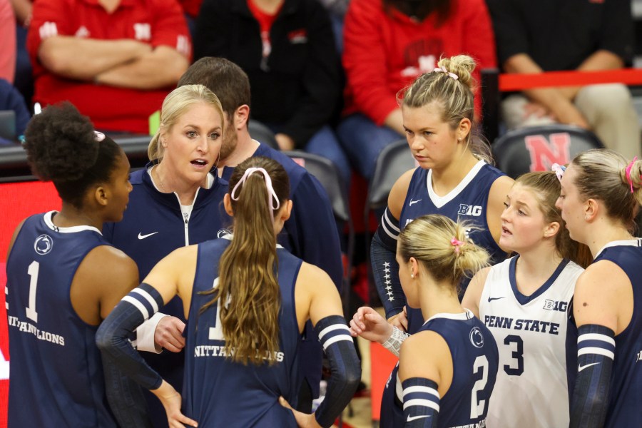 FILE -Penn State head coach Katie Schumacher-Cawley, second from left, talks with her team during a timeout during the first set of an NCAA college volleyball match against Nebraska, Saturday, Oct. 14, 2023, in Lincoln, Neb. (Nikos Frazier/Omaha World-Herald via AP, File)