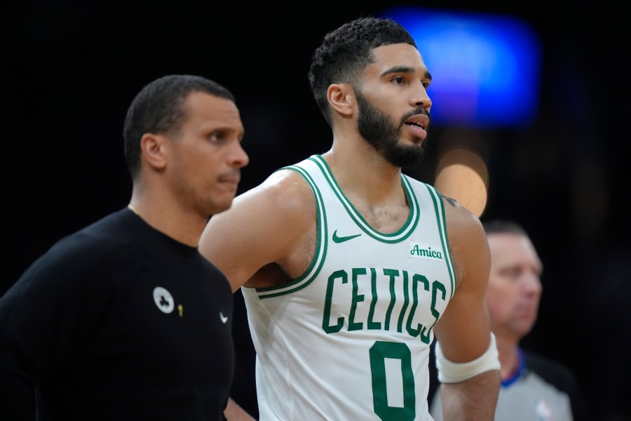 Boston Celtics head coach Joe Mazzulla, left, and forward Jayson Tatum (0) look on from the bench in the second half of an NBA basketball game against the Chicago Bulls, Thursday, Dec. 19, 2024, in Boston. (AP Photo/Steven Senne)