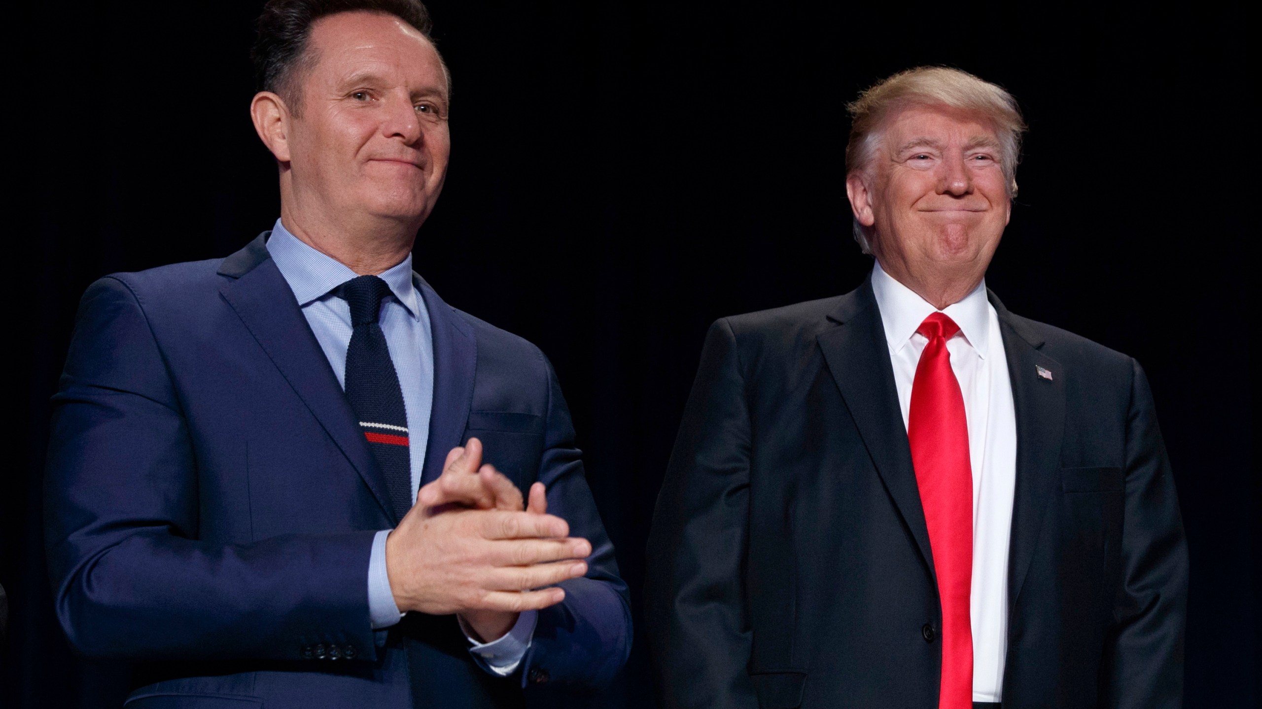 FILE - Television producer Mark Burnett, left, looks on as President Donald Trump arrives for the National Prayer Breakfast, Feb. 2, 2017, in Washington. (AP Photo/Evan Vucci, File)