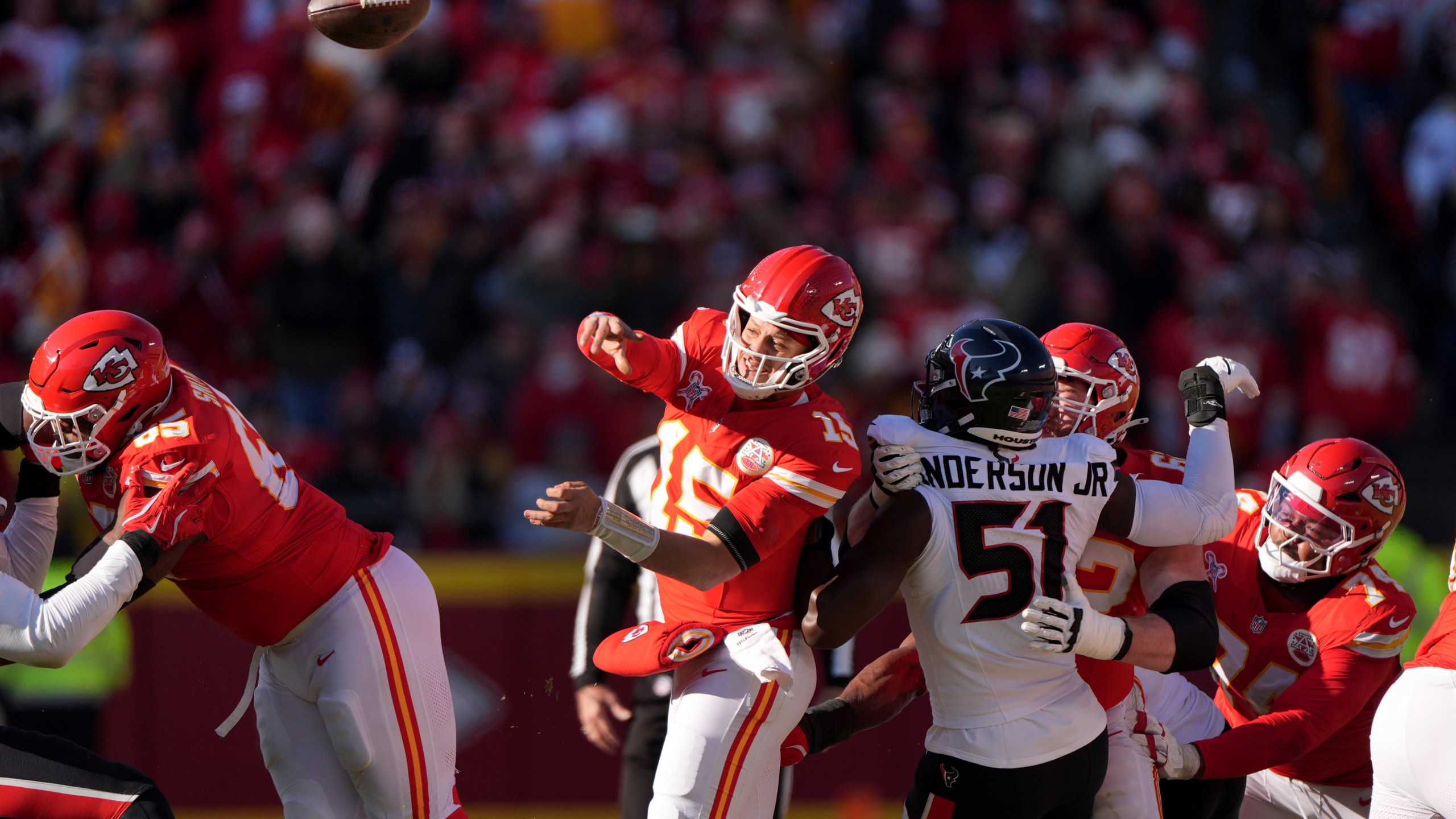 Kansas City Chiefs quarterback Patrick Mahomes (15) throws as Houston Texans defensive end Will Anderson Jr. (51) defends during the first half of an NFL football game Saturday, Dec. 21, 2024, in Kansas City, Mo. (AP Photo/Charlie Riedel)