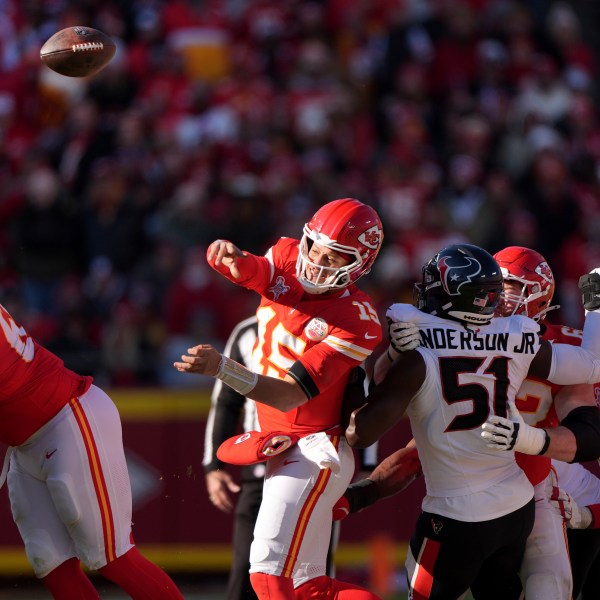 Kansas City Chiefs quarterback Patrick Mahomes (15) throws as Houston Texans defensive end Will Anderson Jr. (51) defends during the first half of an NFL football game Saturday, Dec. 21, 2024, in Kansas City, Mo. (AP Photo/Charlie Riedel)