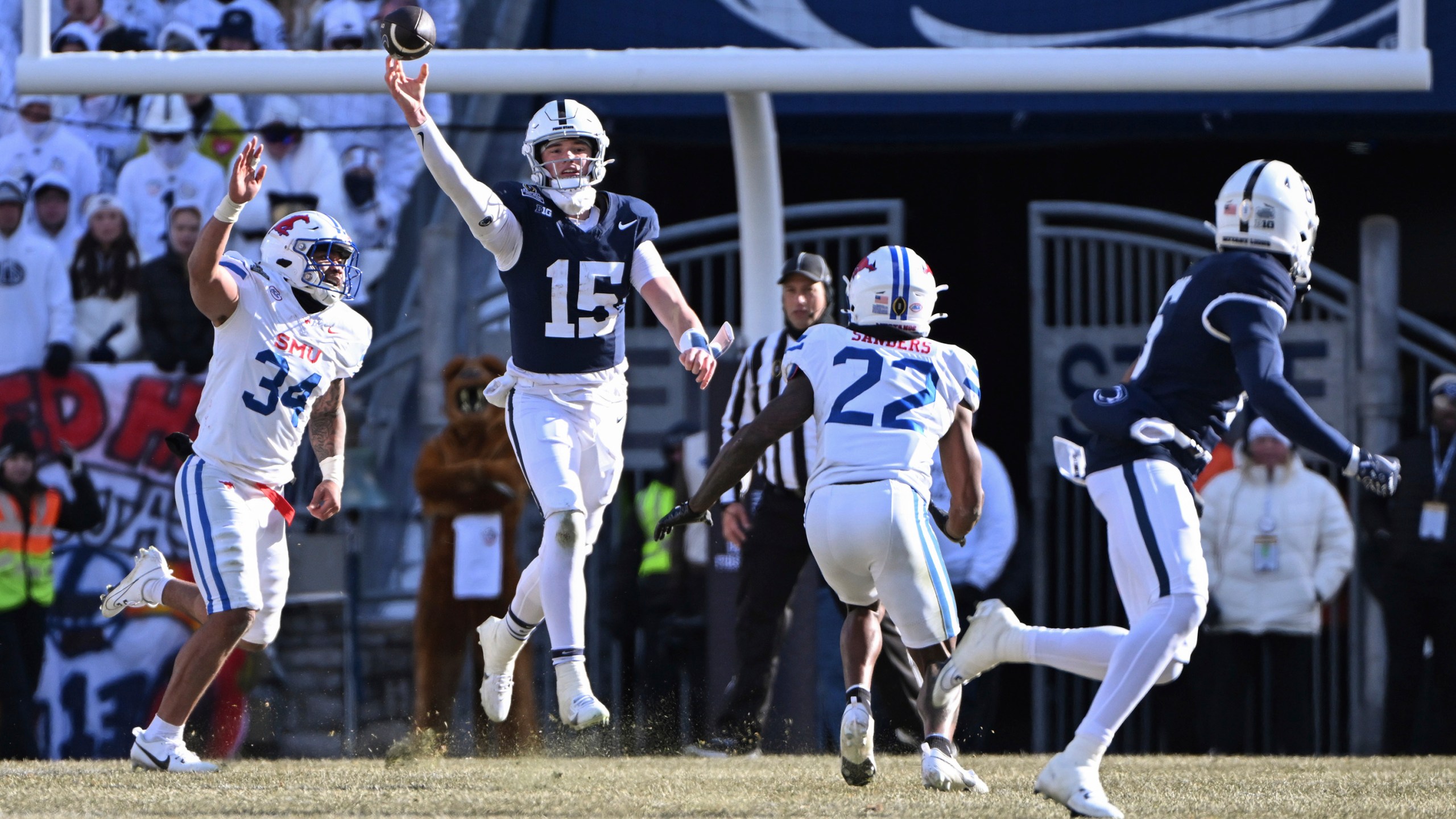 Penn State quarterback Drew Allar throws a pass to wide receiver Harrison Wallace III as SMU safety Cale Sanders Jr. (22) defends during the first half in the first round of the NCAA College Football Playoff, Saturday, Dec. 21, 2024, in State College, Pa. (AP Photo/Barry Reeger)