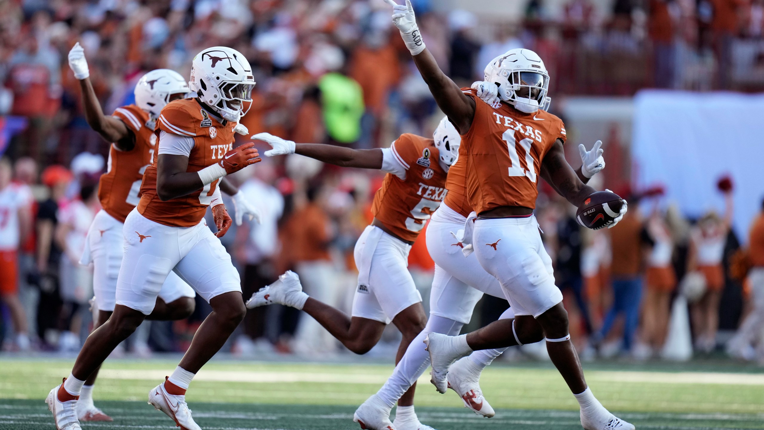 Texas linebacker Colin Simmons (11) celebrates with teammates after an interception during the first half against Clemson in the first round of the College Football Playoff, Saturday, Dec. 21, 2024, in Austin, Texas. (AP Photo/Eric Gay)