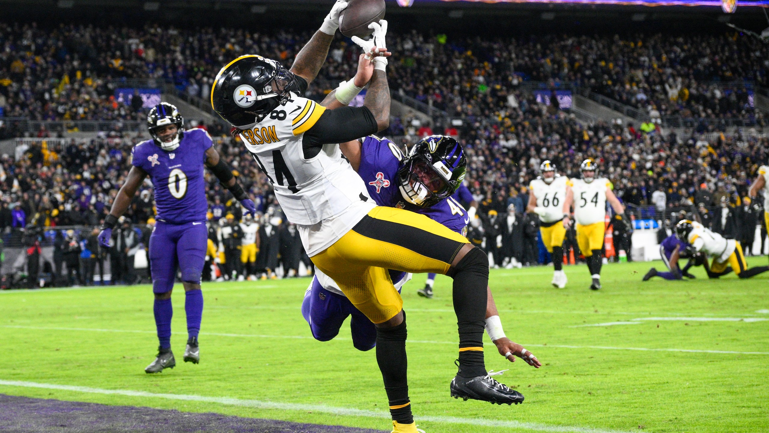 Pittsburgh Steelers running back Cordarrelle Patterson (84) catches a touchdown pass as Baltimore Ravens linebacker Malik Harrison defends during the second half of an NFL football game, Saturday, Dec. 21, 2024, in Baltimore. (AP Photo/Nick Wass)