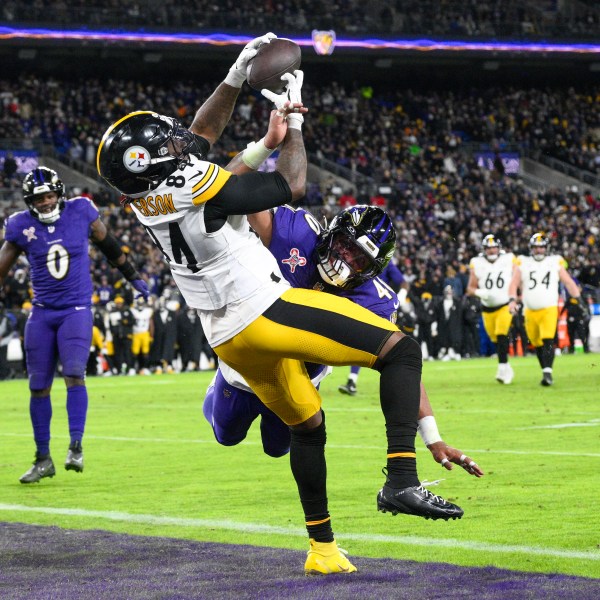 Pittsburgh Steelers running back Cordarrelle Patterson (84) catches a touchdown pass as Baltimore Ravens linebacker Malik Harrison defends during the second half of an NFL football game, Saturday, Dec. 21, 2024, in Baltimore. (AP Photo/Nick Wass)