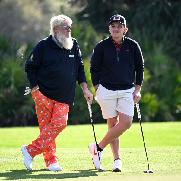 John Daly, left, and his son John Daly II wait to putt on the third green hole during the first round of the PNC Championship golf tournament, Saturday, Dec. 21, 2024, in Orlando, Fla. (AP Photo/Phelan M. Ebenhack)