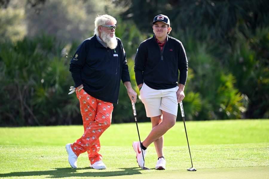 John Daly, left, and his son John Daly II wait to putt on the third green hole during the first round of the PNC Championship golf tournament, Saturday, Dec. 21, 2024, in Orlando, Fla. (AP Photo/Phelan M. Ebenhack)