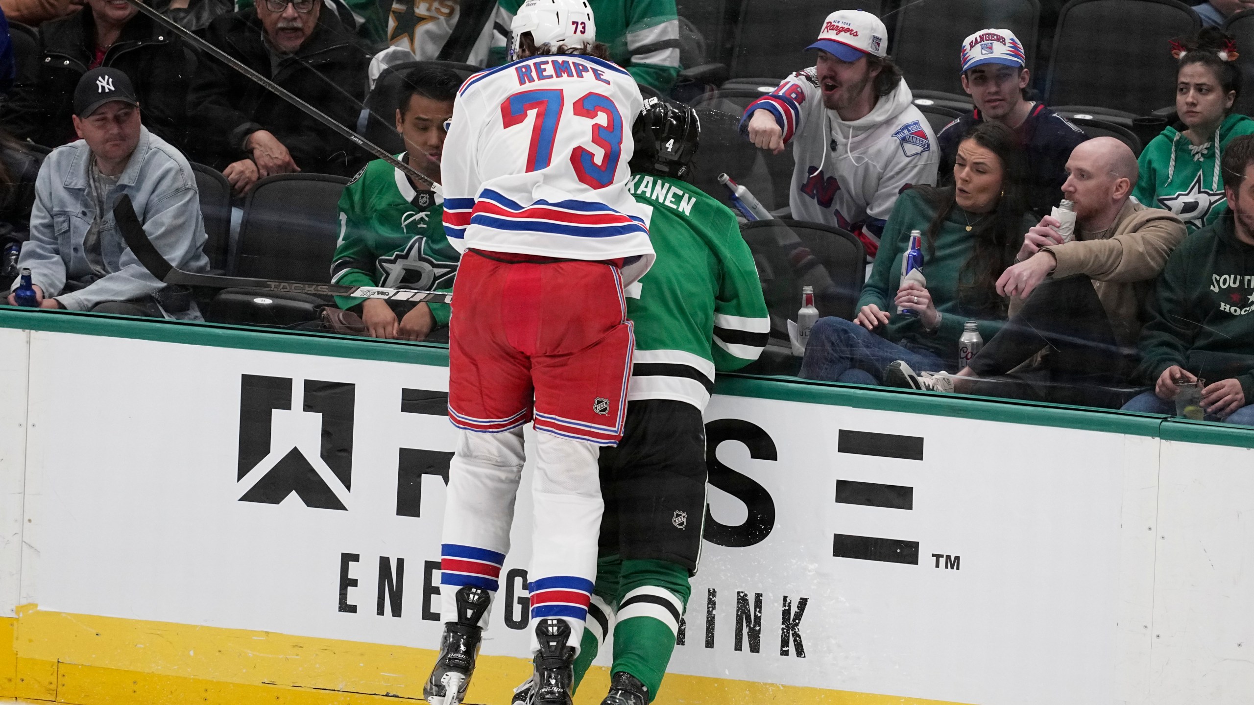 New York Rangers center Matt Rempe (73), who was ejected for game misconduct, slams Dallas Stars' Miro Heiskanen (4) against the boards in the third period of an NHL hockey game in Dallas, Friday, Dec. 20, 2024. (AP Photo/Tony Gutierrez)