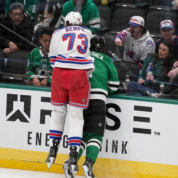 New York Rangers center Matt Rempe (73), who was ejected for game misconduct, slams Dallas Stars' Miro Heiskanen (4) against the boards in the third period of an NHL hockey game in Dallas, Friday, Dec. 20, 2024. (AP Photo/Tony Gutierrez)