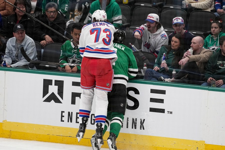 New York Rangers center Matt Rempe (73), who was ejected for game misconduct, slams Dallas Stars' Miro Heiskanen (4) against the boards in the third period of an NHL hockey game in Dallas, Friday, Dec. 20, 2024. (AP Photo/Tony Gutierrez)