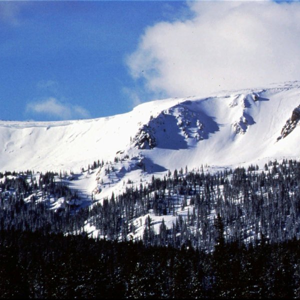 FILE - The sun shines onto Vasquez Cirque, new terrain for Winter Park Resort, Feb. 1997, Winter Park, Colo. (AP Photo/Byron Hetzler, File)