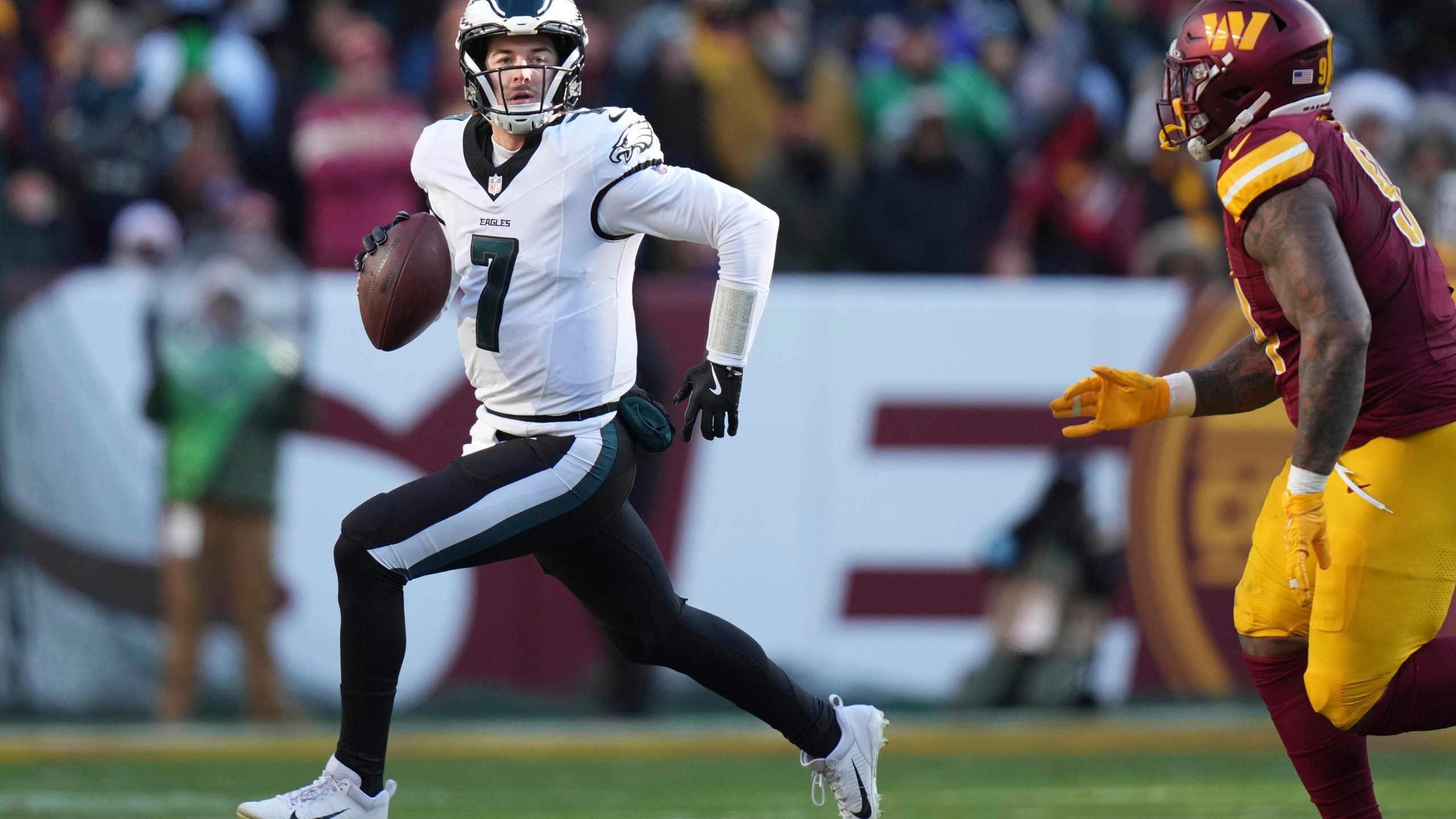 Philadelphia Eagles quarterback Kenny Pickett (7) scrambles out of the pocket during the first half of an NFL football game against the Washington Commanders, Sunday, Dec. 22, 2024, in Landover, Md. (AP Photo/Stephanie Scarbrough)