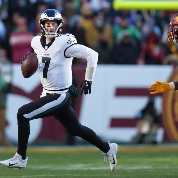 Philadelphia Eagles quarterback Kenny Pickett (7) scrambles out of the pocket during the first half of an NFL football game against the Washington Commanders, Sunday, Dec. 22, 2024, in Landover, Md. (AP Photo/Stephanie Scarbrough)