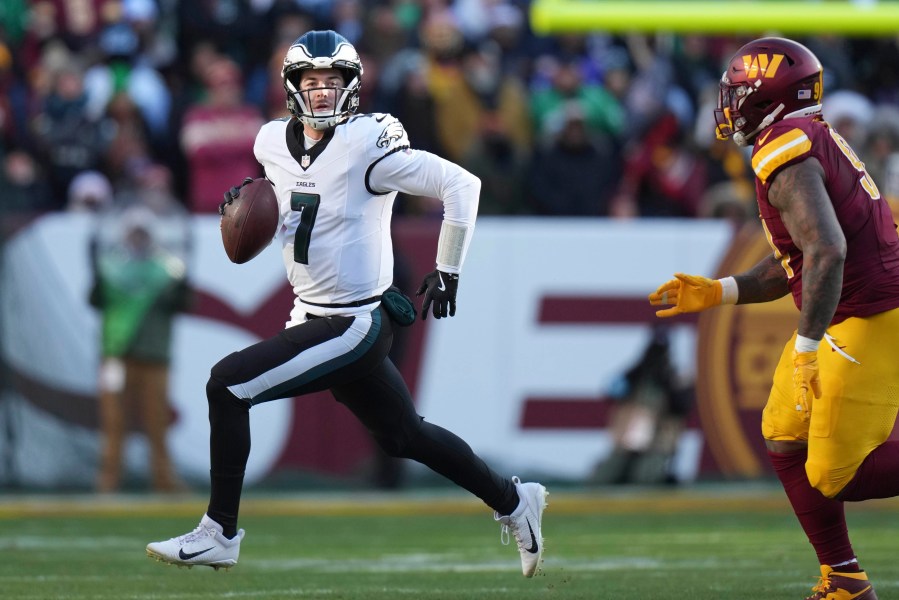 Philadelphia Eagles quarterback Kenny Pickett (7) scrambles out of the pocket during the first half of an NFL football game against the Washington Commanders, Sunday, Dec. 22, 2024, in Landover, Md. (AP Photo/Stephanie Scarbrough)