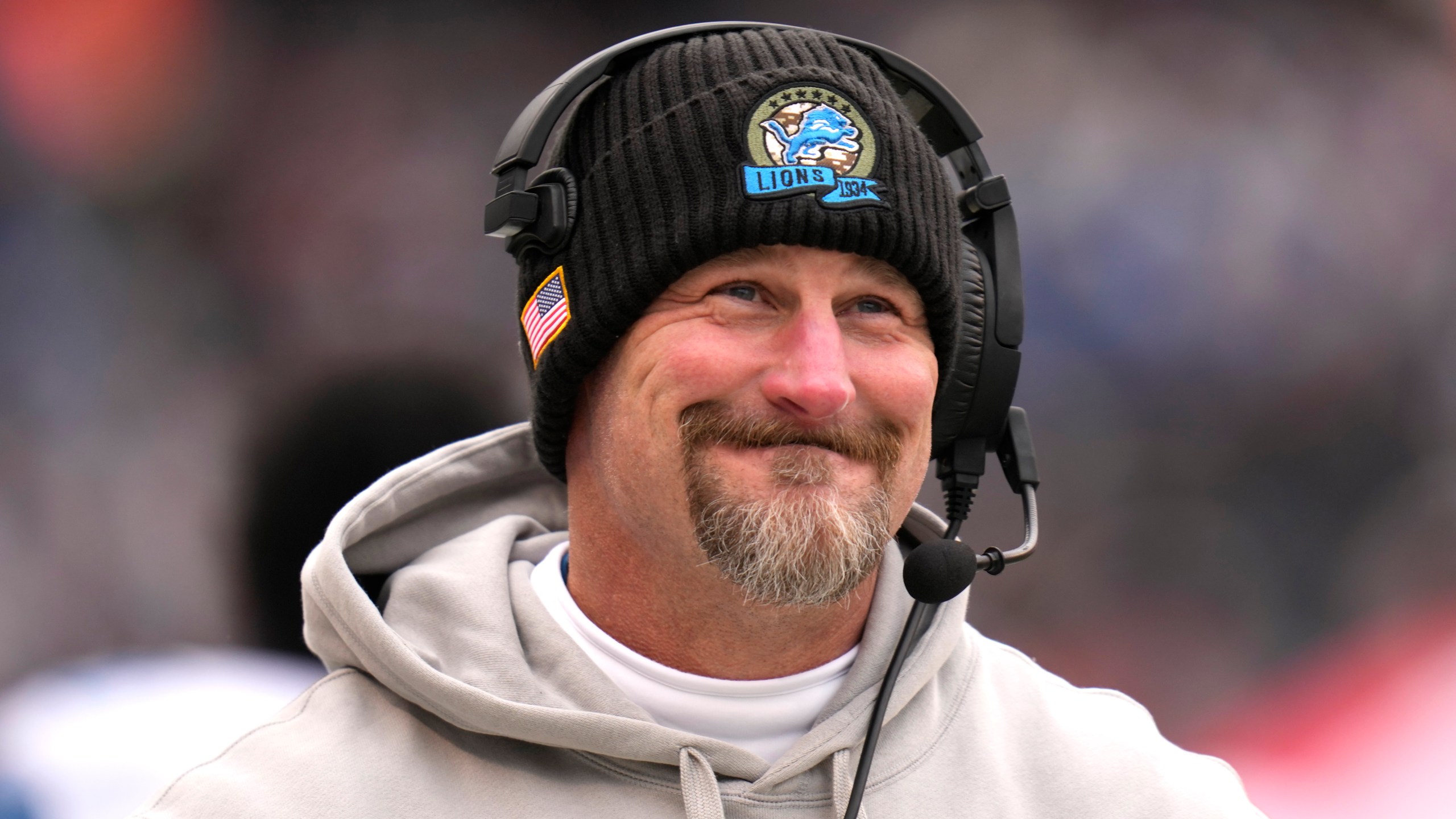 Detroit Lions head coach Dan Campbell smiles along the sidelines during the first half of an NFL football game against the Chicago Bears on Sunday, Dec. 22, 2024, in Chicago. (AP Photo/Erin Hooley)