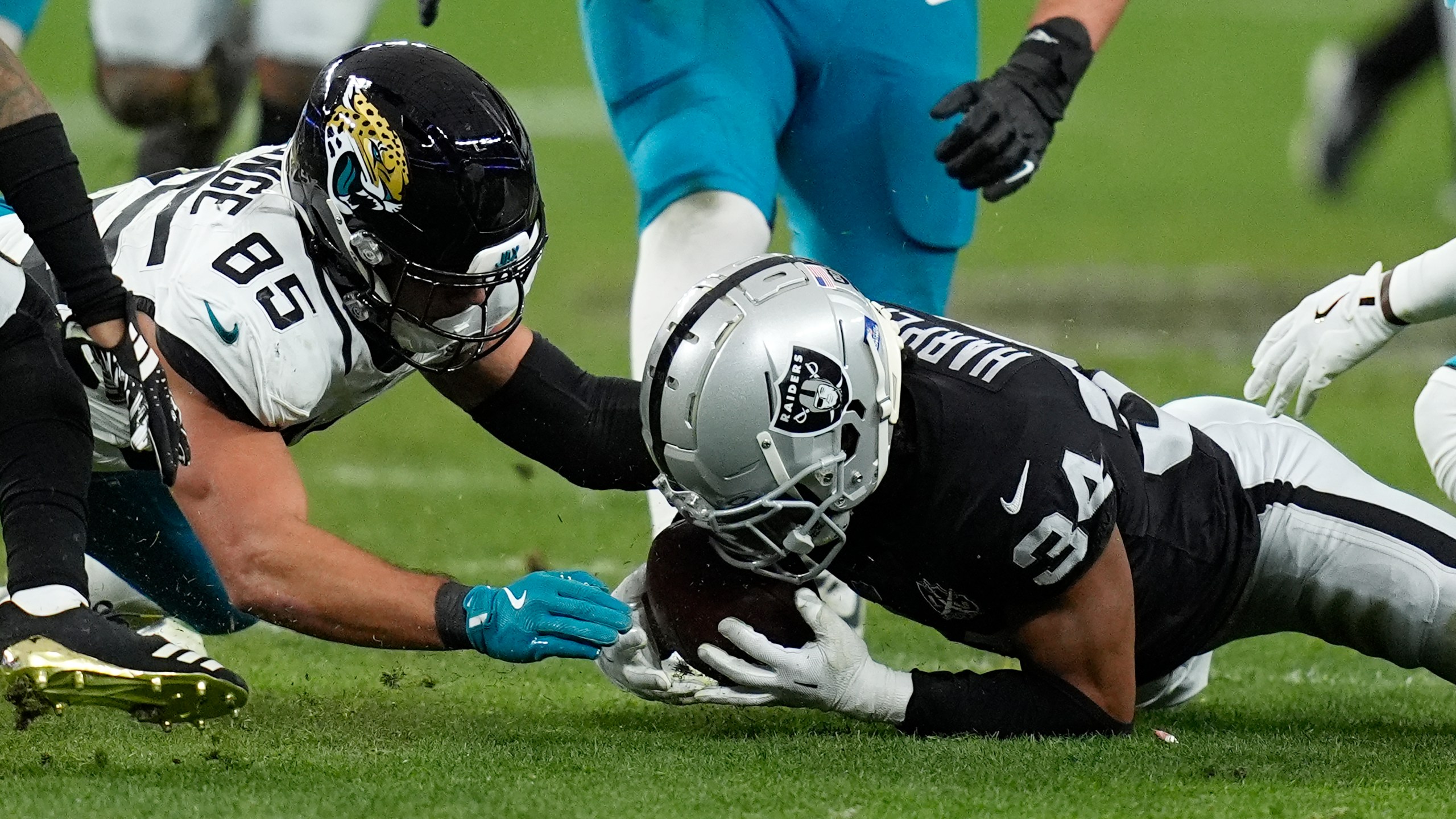 Las Vegas Raiders safety Thomas Harper (34) recovers a rumble against Jacksonville Jaguars tight end Brenton Strange (85) during the first half of an NFL football game Sunday, Dec. 22, 2024, in Las Vegas. (AP Photo/John Locher)