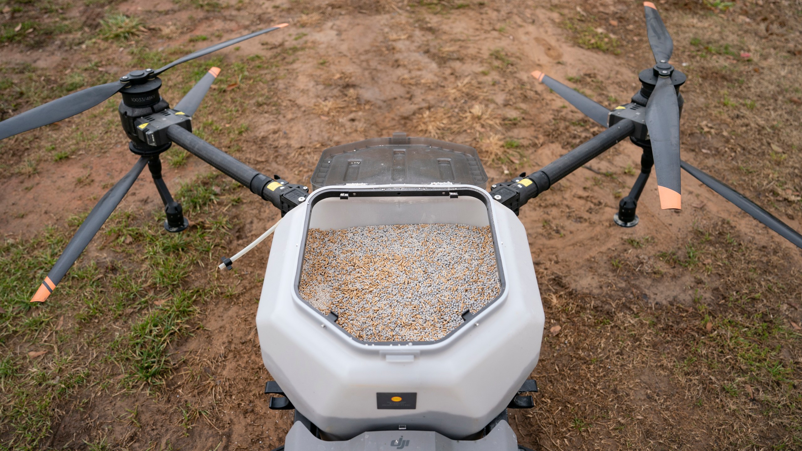 Russell Hedrick uses a DJI drone to put crop cover on his farm, Tuesday, Dec. 17, 2024, in Hickory, N.C. (AP Photo/Allison Joyce)