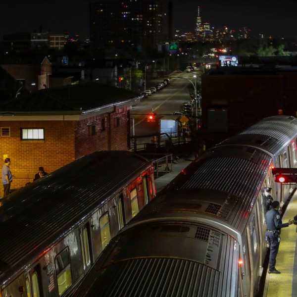 FILE - New York Police officers clear a train at the Coney Island Stillwell Avenue Terminal, May 5, 2020, in the Brooklyn borough of New York. (AP Photo/Frank Franklin II, file)