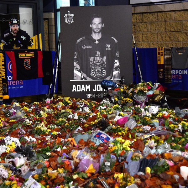 FILE - Flower tributes for Nottingham Panthers player Adam Johnson rest outside the Motorpoint Arena before a memorial ice hockey game between Nottingham Panthers and Manchester Storm in Nottingham, England, Nov. 18, 2023. (AP Photo/Rui Vieira, File)