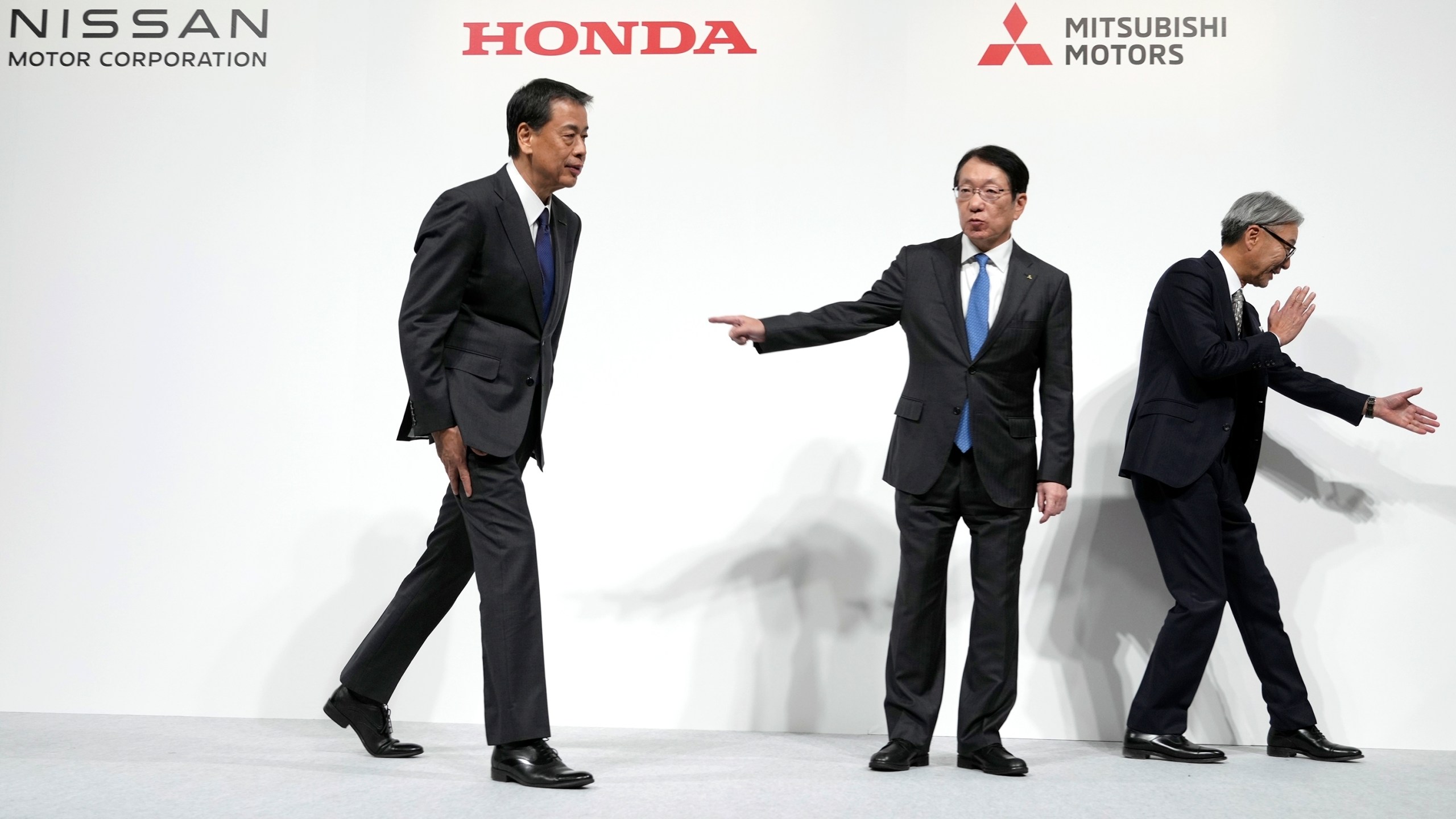 Nissan Chief Executive Makoto Uchida, left, Takao Kato, CEO of Mitsubishi Motors, center, and Honda Chief Executive Toshihiro Mibe, right, leave after a joint news conference in Tokyo, Japan, Monday, Dec. 23, 2024. (AP Photo/Eugene Hoshiko)