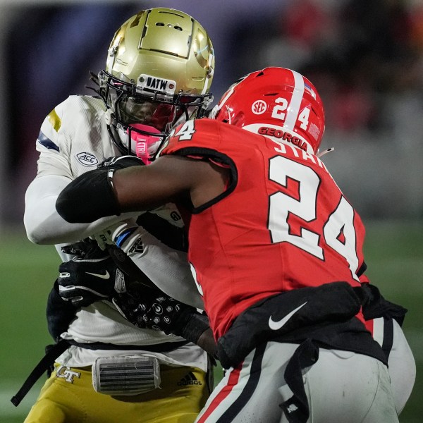 Georgia Tech wide receiver Eric Singleton Jr. (2) runs into Georgia defensive back Malaki Starks (24) during the first half of an NCAA college football game, Friday, Nov. 29, 2024, in Athens, Ga. (AP Photo/Mike Stewart)