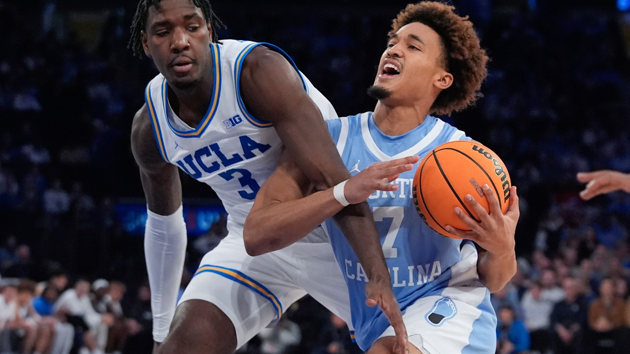 North Carolina's Seth Trimble (7) drives past UCLA's Eric Dailey Jr. (3) during the second half of an NCAA college basketball game in the CBS Sports Classic, Saturday, Dec. 21, 2024, in New York. (AP Photo/Frank Franklin II)