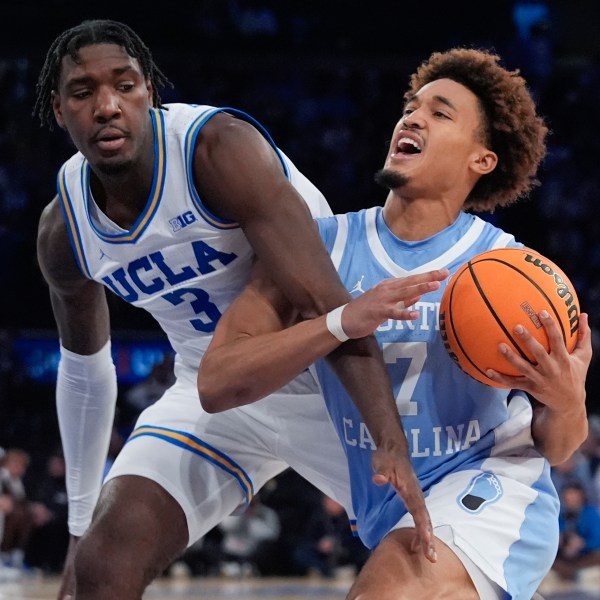 North Carolina's Seth Trimble (7) drives past UCLA's Eric Dailey Jr. (3) during the second half of an NCAA college basketball game in the CBS Sports Classic, Saturday, Dec. 21, 2024, in New York. (AP Photo/Frank Franklin II)