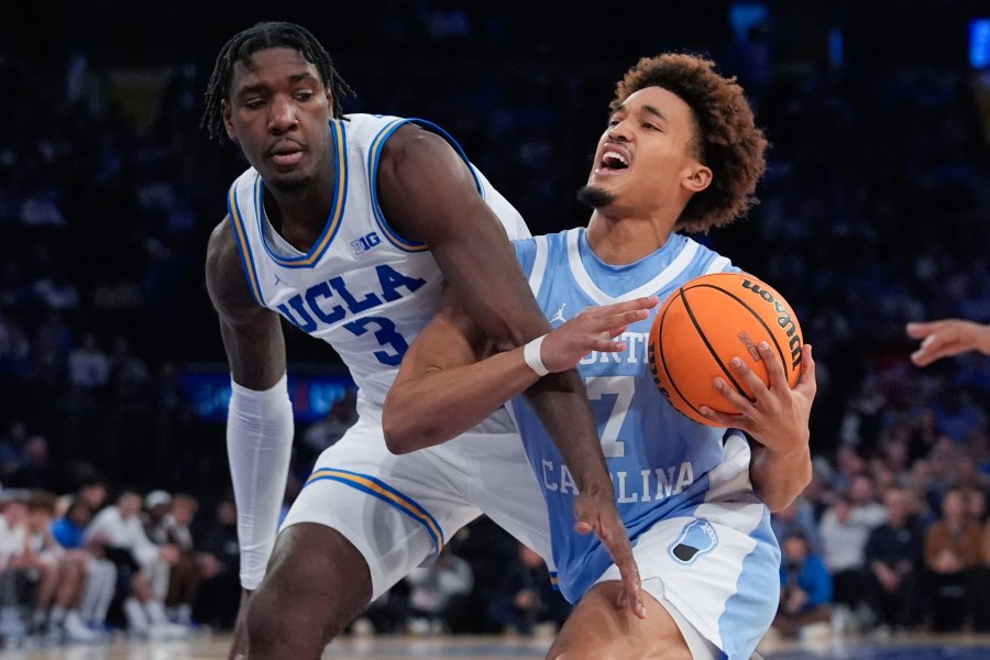 North Carolina's Seth Trimble (7) drives past UCLA's Eric Dailey Jr. (3) during the second half of an NCAA college basketball game in the CBS Sports Classic, Saturday, Dec. 21, 2024, in New York. (AP Photo/Frank Franklin II)