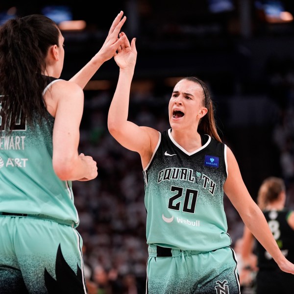 FILE - New York Liberty guard Sabrina Ionescu (20) reacts with forward Breanna Stewart (30) at the end of the first half of Game 4 of a WNBA basketball final playoff series against the Minnesota Lynx, Friday, Oct. 18, 2024, in Minneapolis. (AP Photo/Abbie Parr, File)