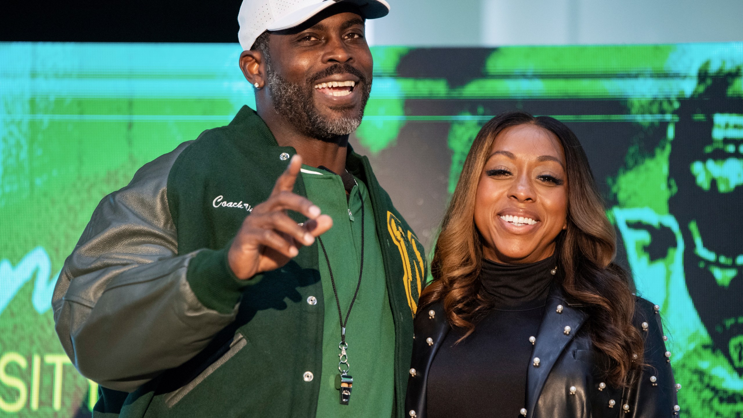 Michael Vick and his wife Kijafa Vick pose for a photo after he was named the next head coach of the Norfolk State University football team durning a press conference on Monday, Dec. 23, 2024 in Norfolk, Va. (AP Photo/Mike Caudill)