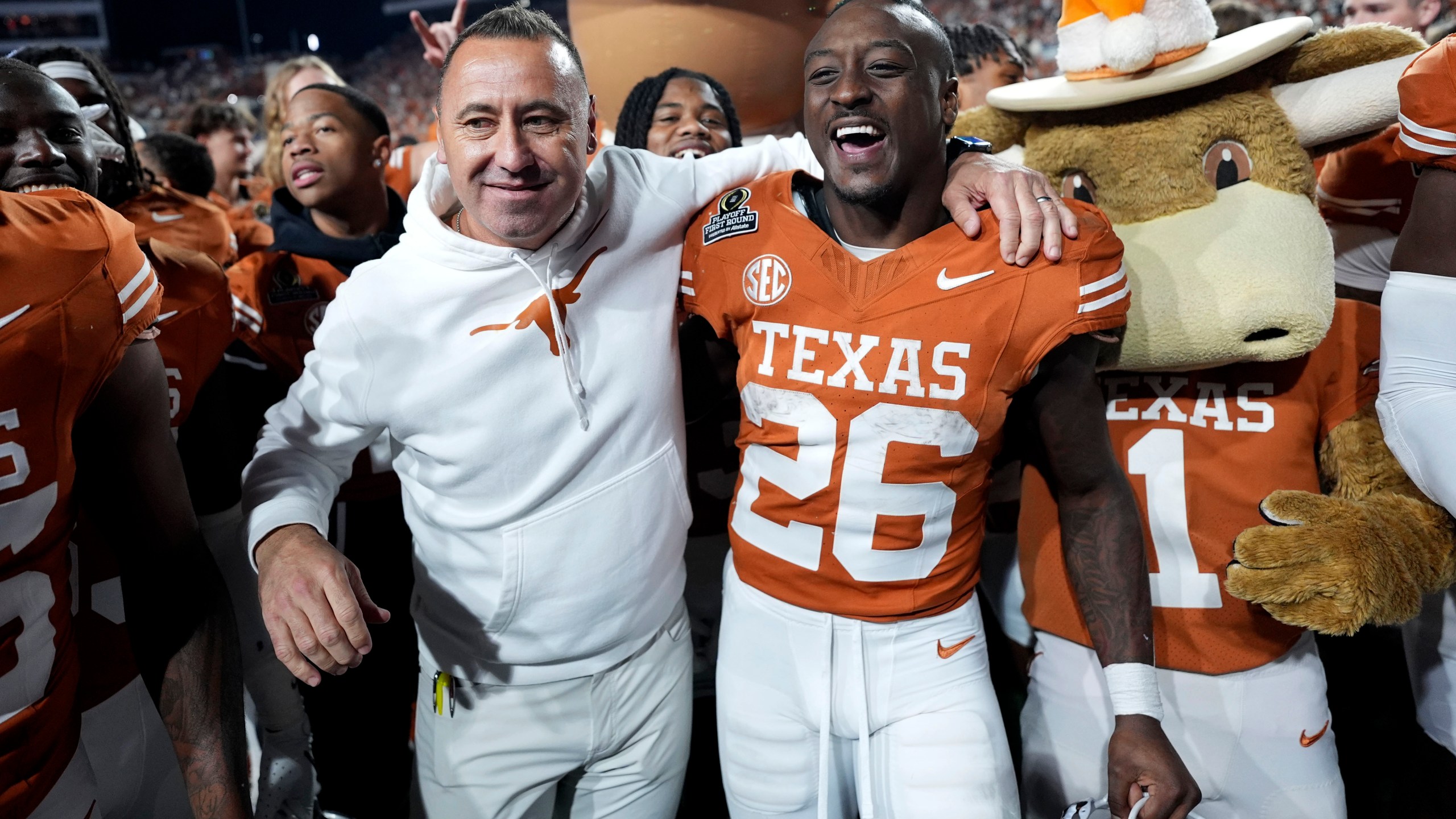 Texas head coach Steve Sarkisian celebrates with running back Quintrevion Wisner (26) after a first round game against Clemson in the College Football Playoff, Saturday, Dec. 21, 2024, in Austin, Texas. (AP Photo/Eric Gay)