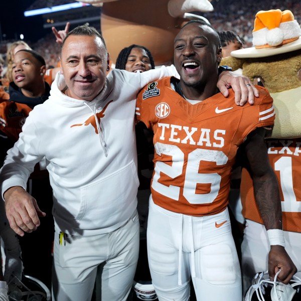 Texas head coach Steve Sarkisian celebrates with running back Quintrevion Wisner (26) after a first round game against Clemson in the College Football Playoff, Saturday, Dec. 21, 2024, in Austin, Texas. (AP Photo/Eric Gay)