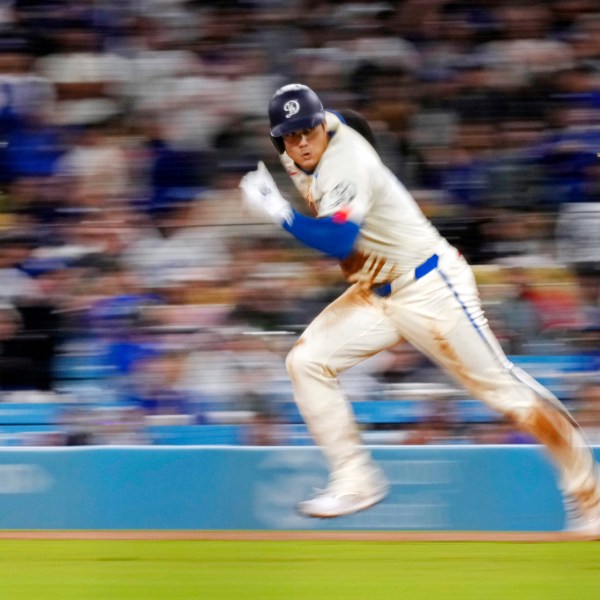 FILE - Los Angeles Dodgers' Shohei Ohtani runs from first on his way to stealing second during the ninth inning of a baseball game against the Colorado Rockies, Saturday, Sept. 21, 2024, in Los Angeles. (AP Photo/Mark J. Terrill, File)