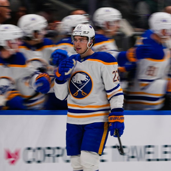 Buffalo Sabres' Jack Quinn (22) celebrates with teammates after scoring a goal during the second period of an NHL hockey game against the New York Islanders Monday, Dec. 23, 2024, in Elmont, N.Y. (AP Photo/Frank Franklin II)