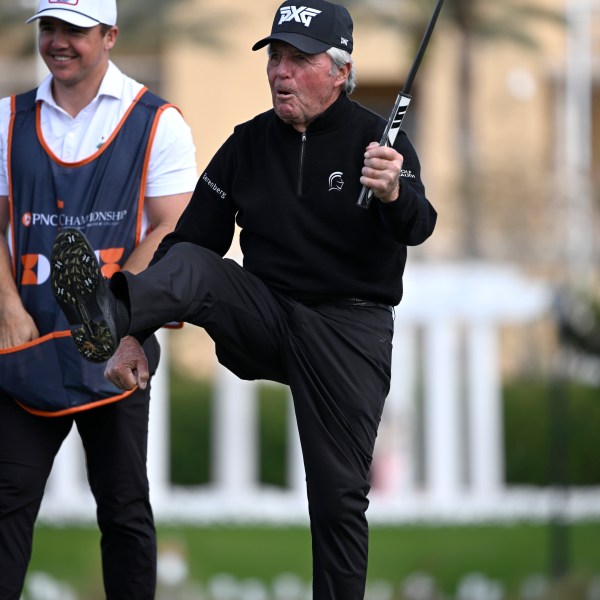 Gary Player, right, celebrates after making a putt on the 18th green as his son Wayne Player looks on during the final round of the PNC Championship golf tournament, Sunday, Dec. 22, 2024, in Orlando, Fla. (AP Photo/Phelan M. Ebenhack)