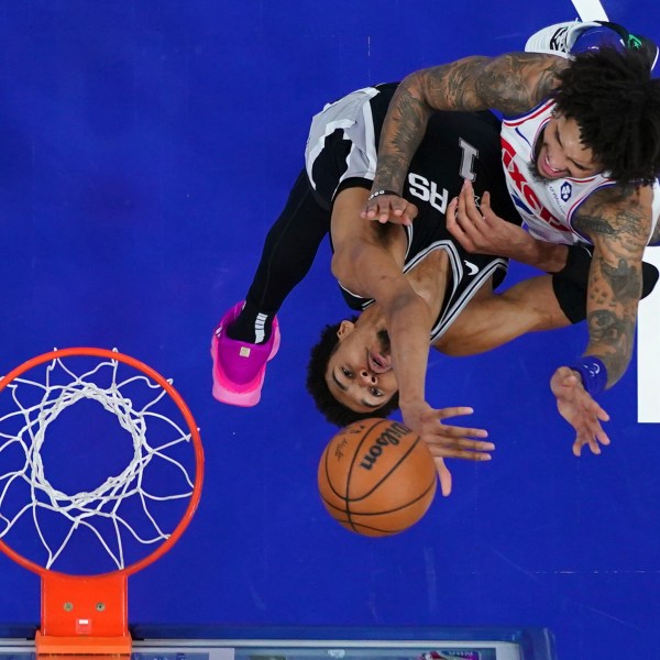 Philadelphia 76ers' Kelly Oubre Jr., right, goes up for a shot against San Antonio Spurs' Victor Wembanyama during the second half of an NBA basketball game, Monday, Dec. 23, 2024, in Philadelphia. (AP Photo/Matt Slocum)