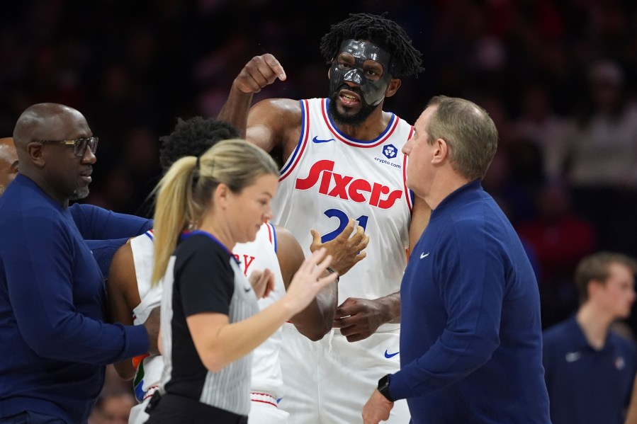 Philadelphia 76ers' Joel Embiid, right, argues with referee Jenna Schroeder during the first half of an NBA basketball game, Monday, Dec. 23, 2024, in Philadelphia. (AP Photo/Matt Slocum)