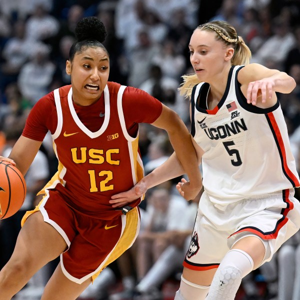 Southern California guard JuJu Watkins (12) is guarded by UConn guard Paige Bueckers (5) in the second half of an NCAA college basketball game, Saturday, Dec. 21, 2024, in Hartford, Conn. (AP Photo/Jessica Hill)