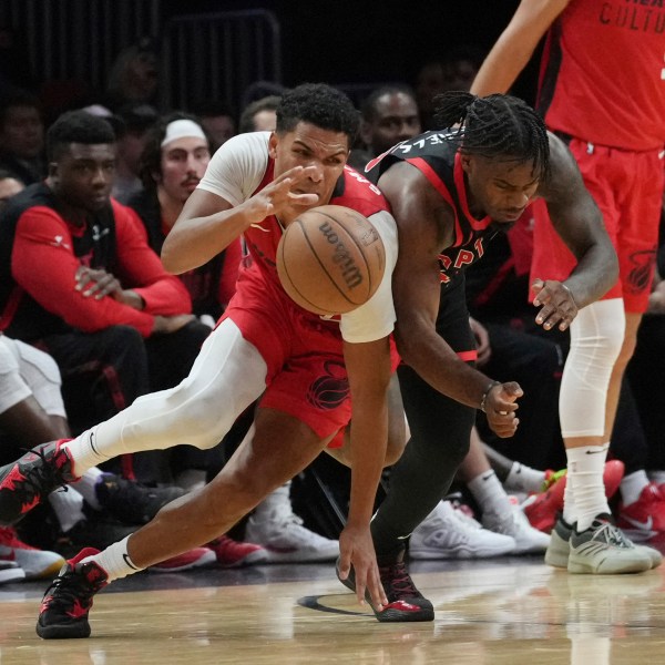 Toronto Raptors guard Davion Mitchell (45) fouls Miami Heat guard Dru Smith (12) during the second half of an NBA basketball game, Thursday, Dec. 12, 2024, in Miami. (AP Photo/Marta Lavandier)