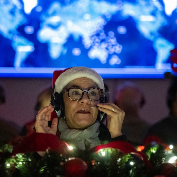 Volunteers answer phone calls from around the world Tuesday, Dec. 24, 2024, at the NORAD Tracks Santa center at Peterson Space Force Base in Colorado Springs, Colo. (Christian Murdock /The Gazette via AP)