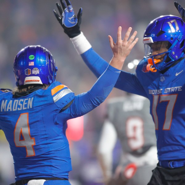 Boise State quarterback Maddux Madsen (4) celebrates after a touchdown run against UNLV with wide receiver Prince Strachan (17) late in the first half of the Mountain West Championship NCAA college football game Friday, Dec. 6, 2024, in Boise, Idaho. (AP Photo/Steve Conner)