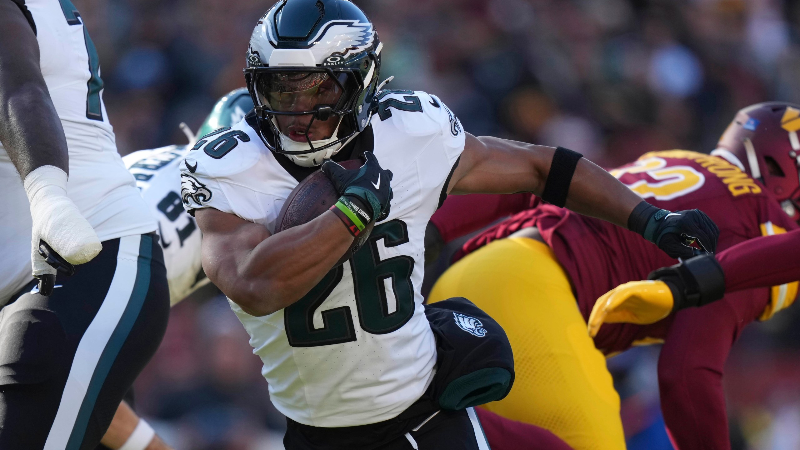 Philadelphia Eagles running back Saquon Barkley (26) running with the ball during the first half of an NFL football game against the Washington Commanders, Sunday, Dec. 22, 2024, in Landover, Md. (AP Photo/Stephanie Scarbrough)