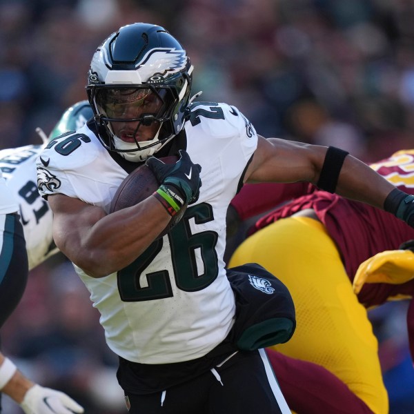 Philadelphia Eagles running back Saquon Barkley (26) running with the ball during the first half of an NFL football game against the Washington Commanders, Sunday, Dec. 22, 2024, in Landover, Md. (AP Photo/Stephanie Scarbrough)