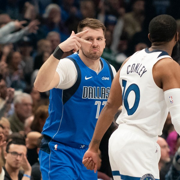 Dallas Mavericks guard Luka Doncic (77) celebrates after hitting a three-pointer over Minnesota Timberwolves guard Mike Conley (10) in the first half of an NBA basketball game on Wednesday, Dec. 25, 2024, in Dallas. (AP Photo/Emil T. Lippe)