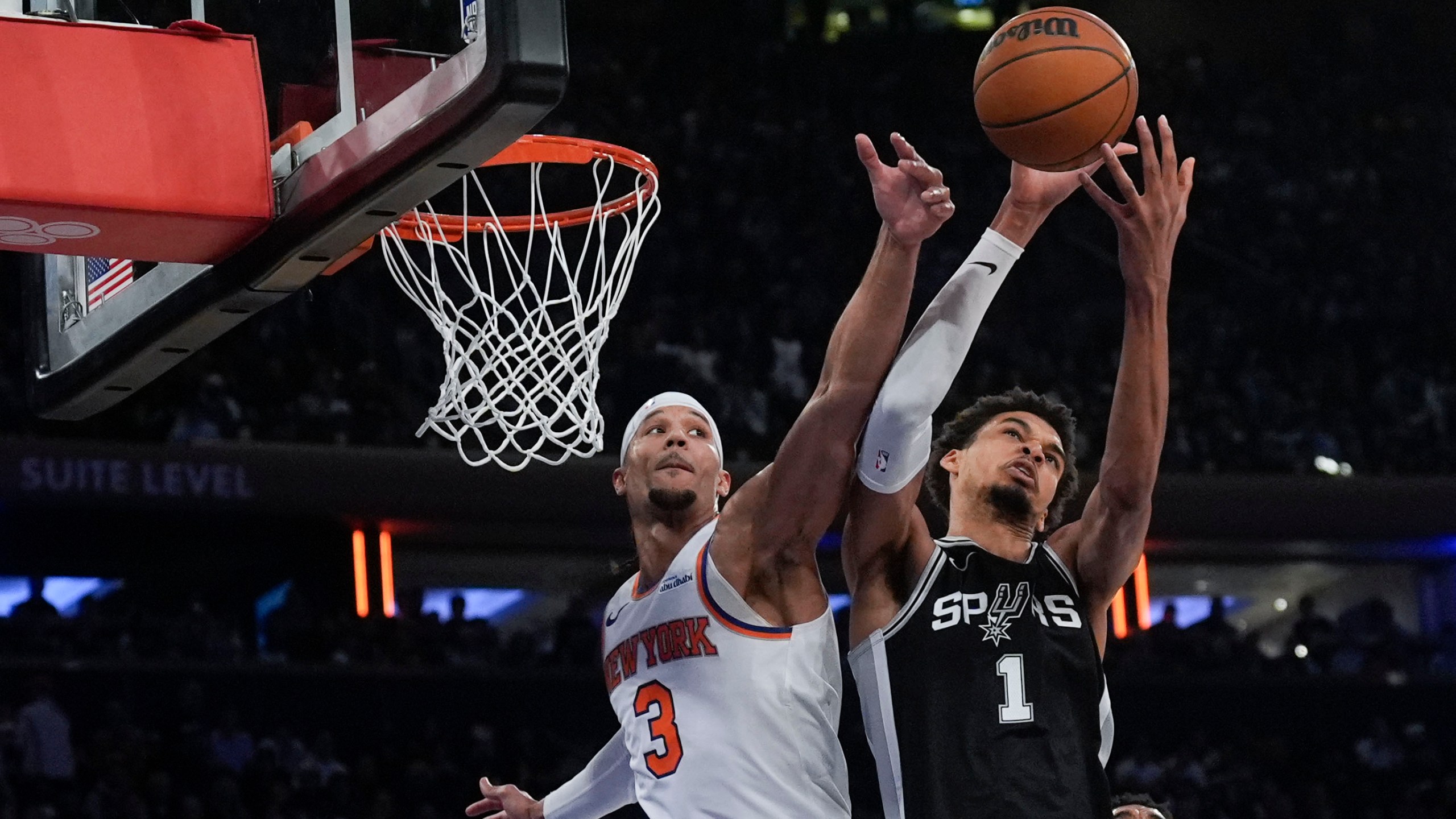 New York Knicks' Josh Hart (3), left, and San Antonio Spurs' Victor Wembanyama fight for a rebound during the second half of an NBA basketball game, Wednesday, Dec. 25, 2024, in New York. The Knicks defeated the Spurs 117-114. (AP Photo/Seth Wenig)